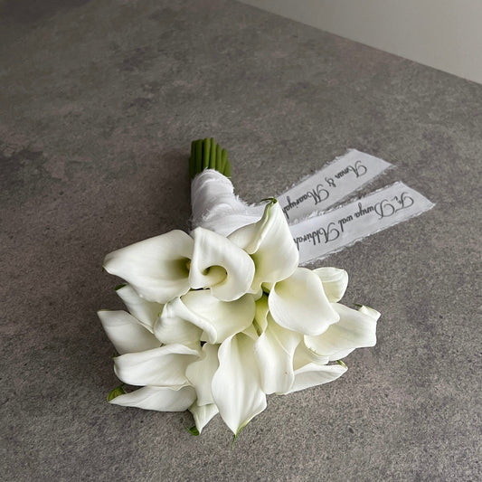 white lily bouquet with a personalised ribbon message