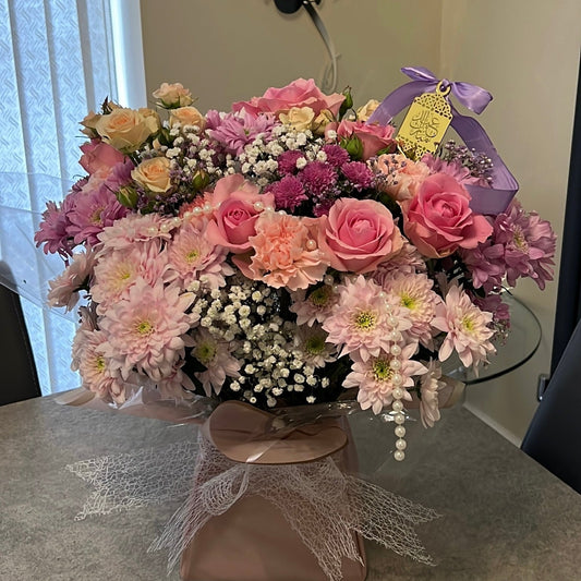 Bouquet of pink and white flowers presented in a box for the home