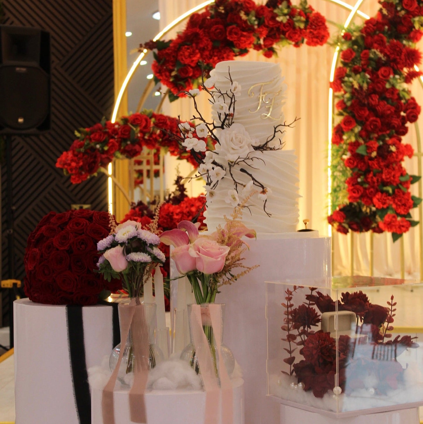 Decorative table setting with flowers and candles on a white surface