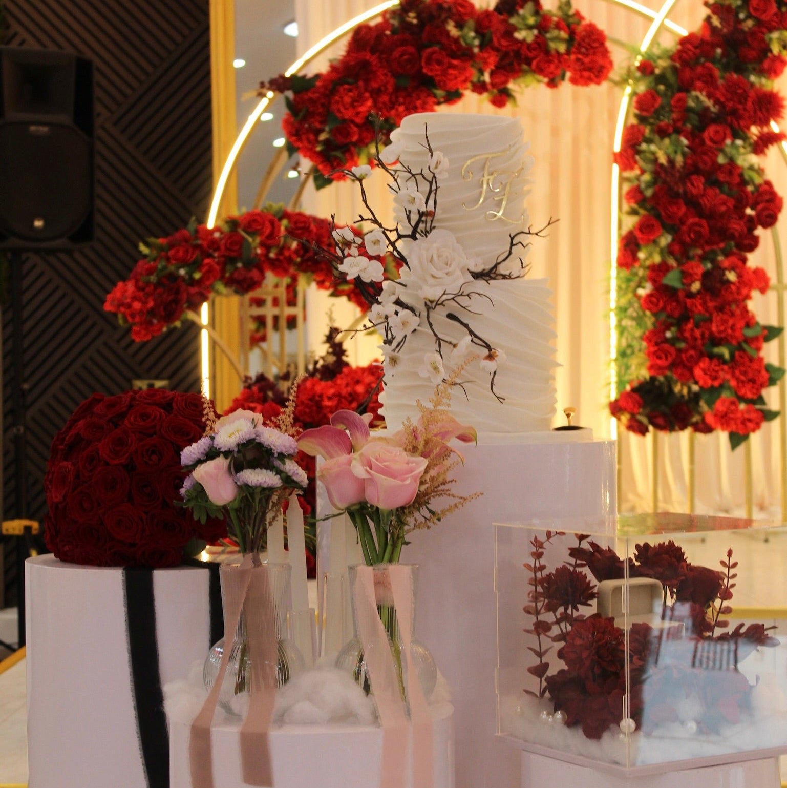 Decorative table setting with flowers and candles on a white surface