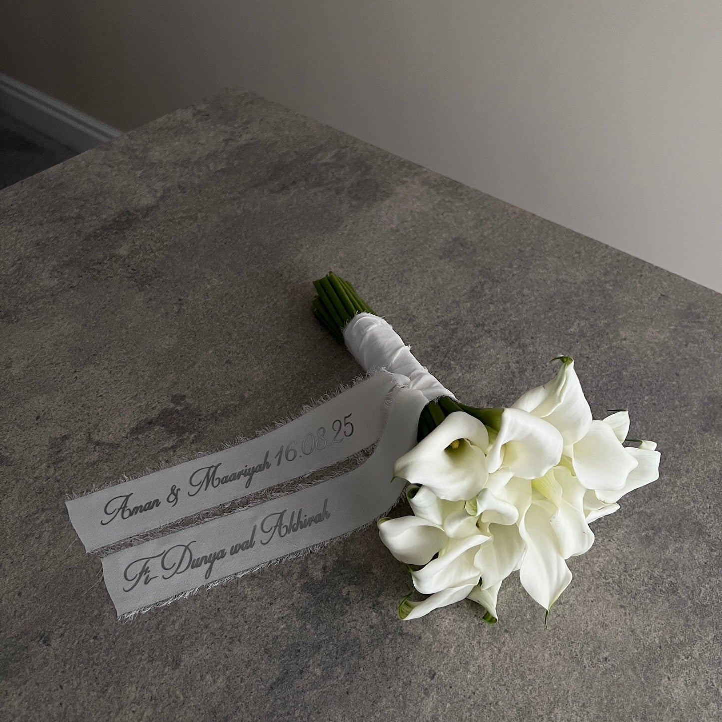 white lily bouquet with a personalised ribbon message