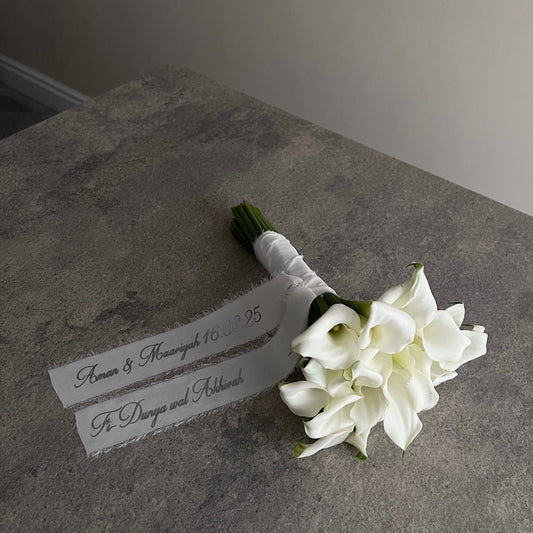 white lily bouquet with a personalised ribbon message