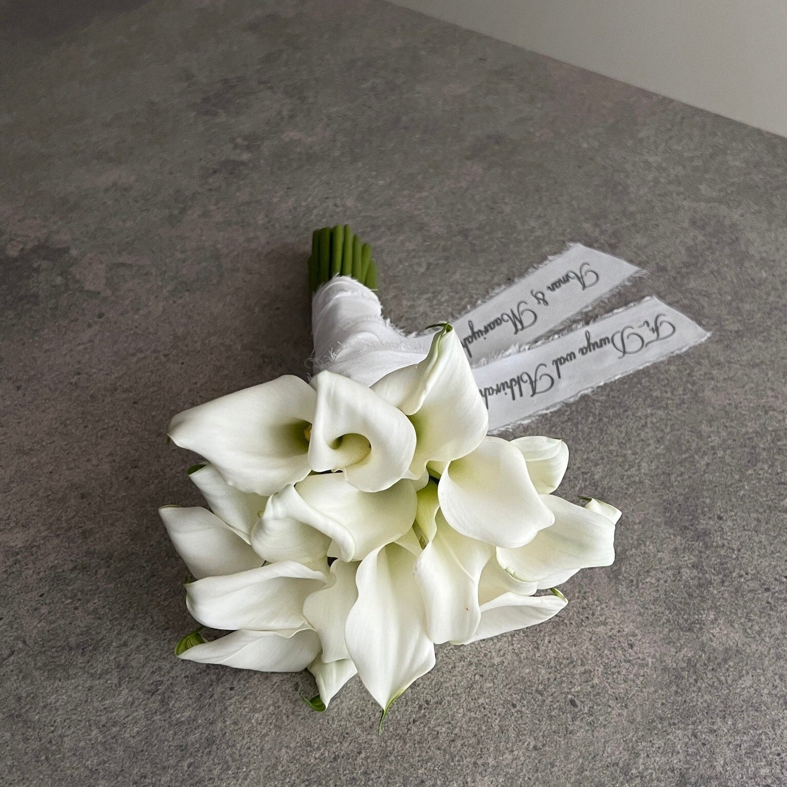 white lily bouquet with a personalised ribbon message