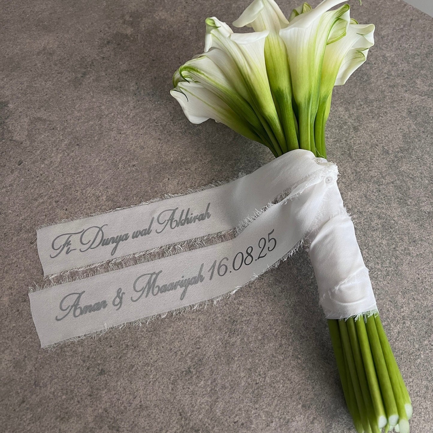 white lily bouquet with a personalised ribbon message