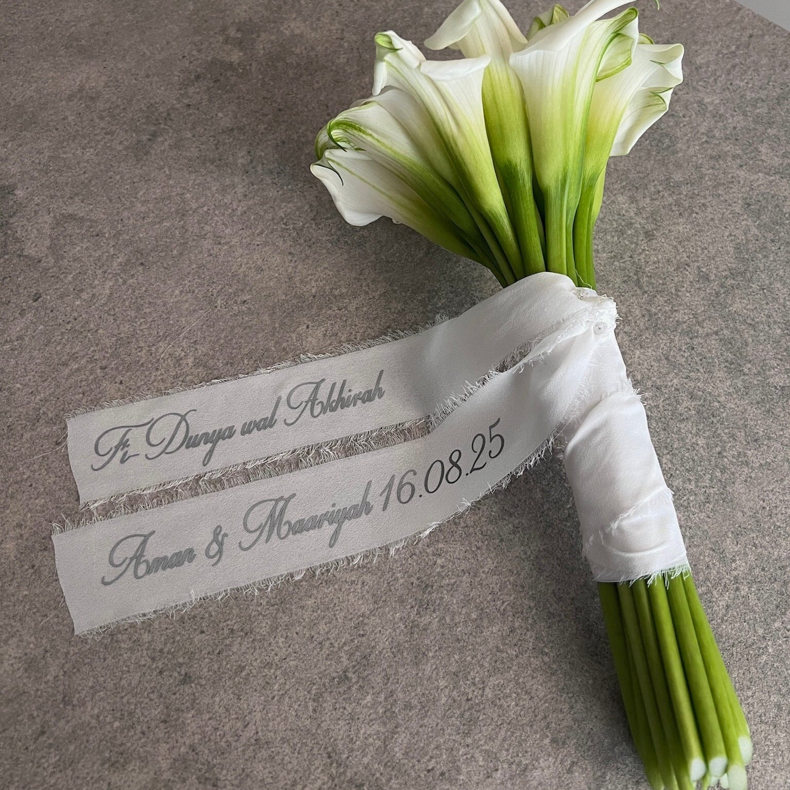 white lily bouquet with a personalised ribbon message
