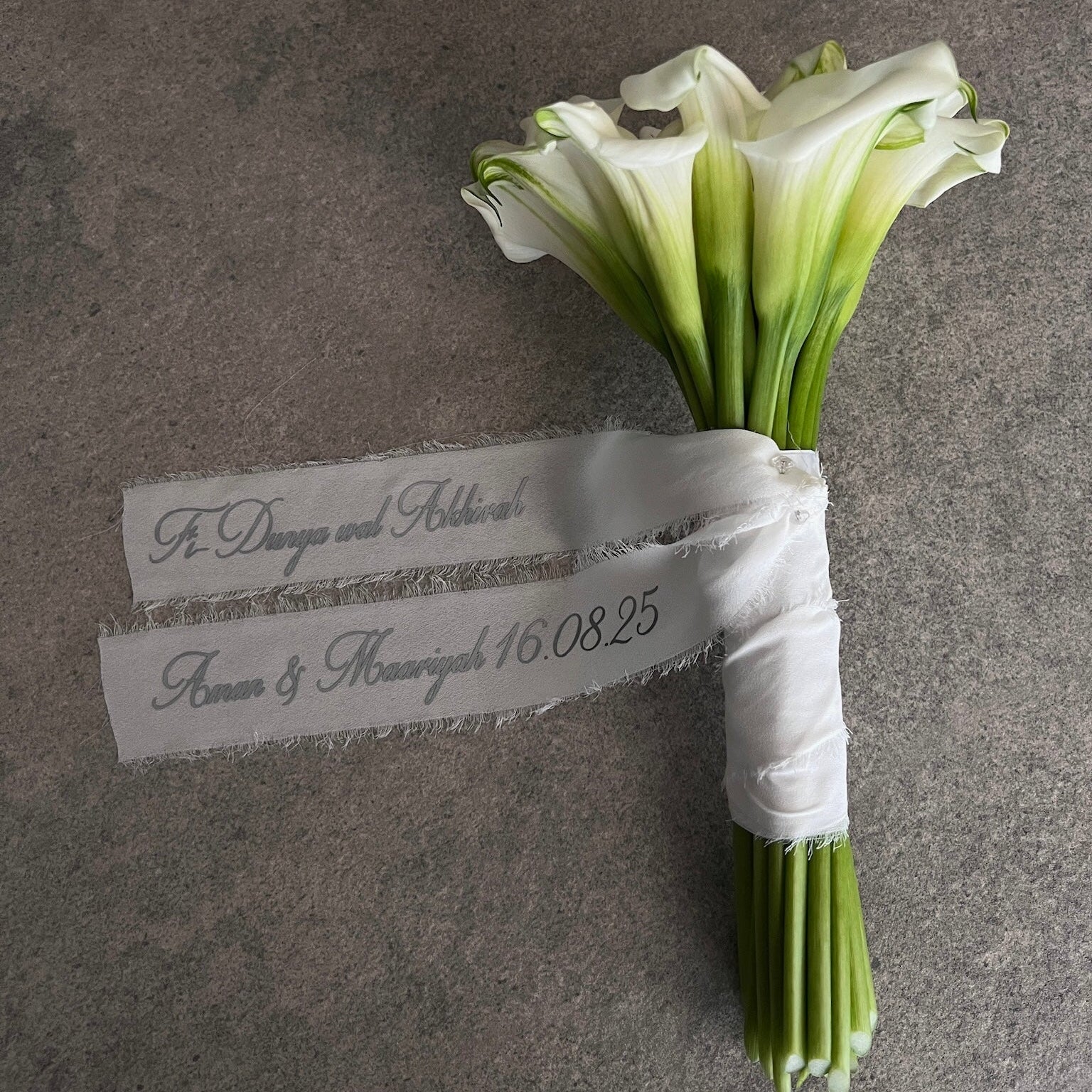 white lily bouquet with a personalised ribbon message